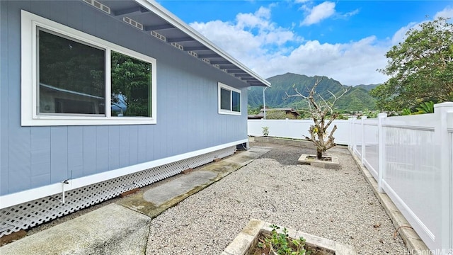 view of property exterior featuring a mountain view and a patio area