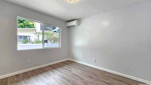 47-433 Hui Nene St, Kaneohe, HI 96744 - spare room featuring an AC wall unit, wood finished floors, and baseboards