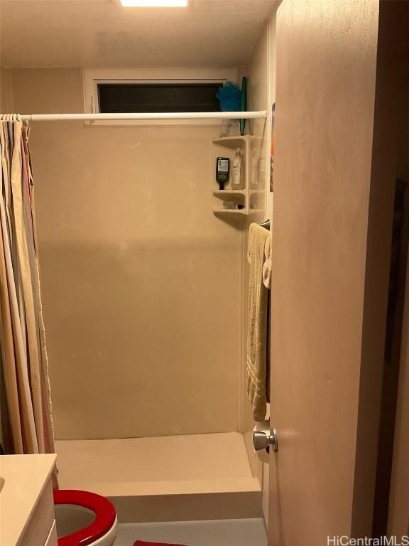 bathroom featuring vanity, toilet, and walk in shower