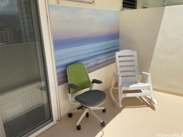 balcony at dusk featuring a water view and a view of the beach