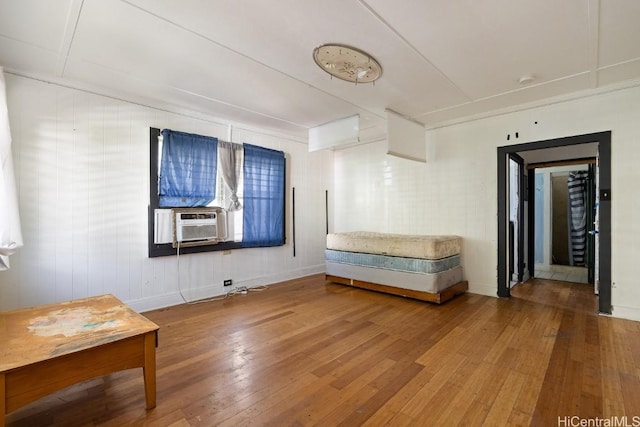 unfurnished room featuring hardwood / wood-style floors and cooling unit