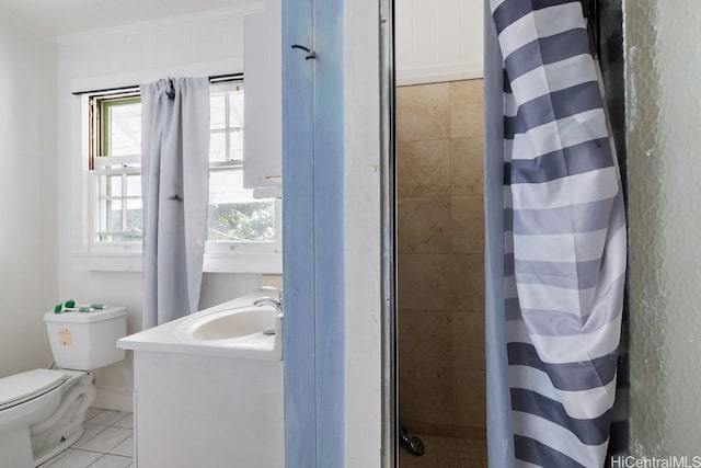 bathroom with walk in shower, ornamental molding, vanity, tile patterned flooring, and toilet