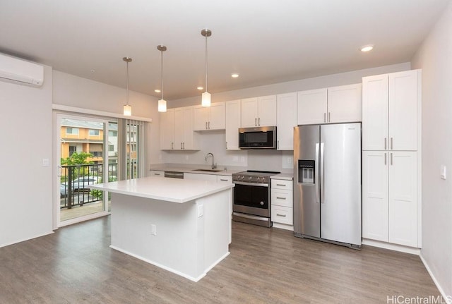 kitchen with pendant lighting, sink, white cabinetry, and stainless steel appliances