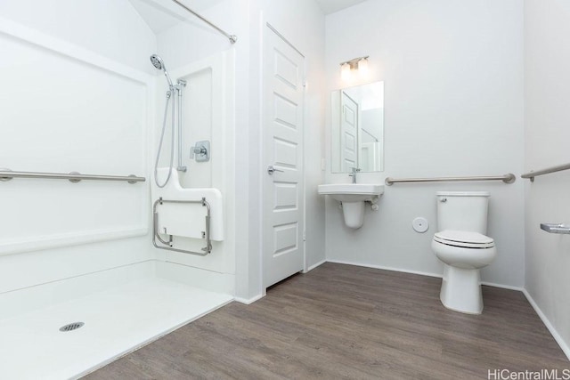 bathroom featuring a shower, toilet, sink, and hardwood / wood-style flooring