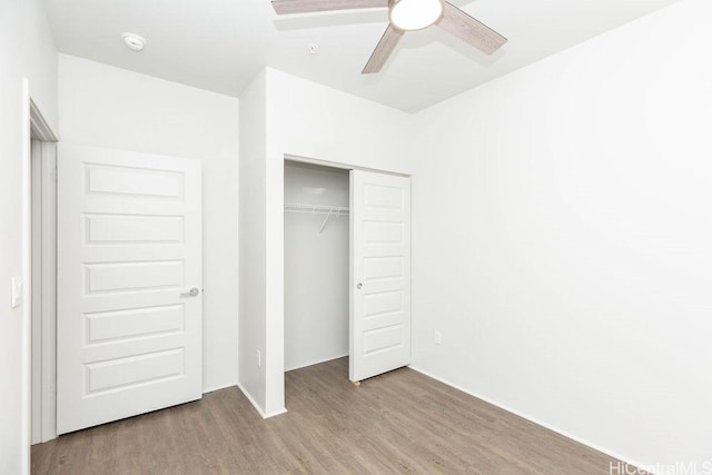 unfurnished bedroom featuring light wood-type flooring, a closet, and ceiling fan