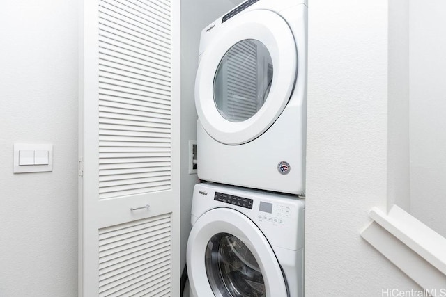 laundry area with stacked washer / drying machine