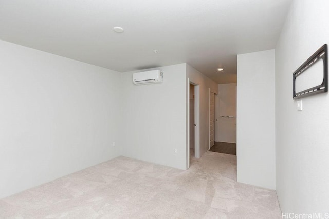 unfurnished room featuring light colored carpet and a wall mounted AC