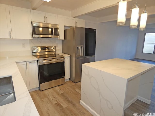 kitchen with beamed ceiling, decorative light fixtures, white cabinetry, and appliances with stainless steel finishes