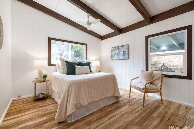 bedroom featuring vaulted ceiling with beams, hardwood / wood-style floors, and ceiling fan