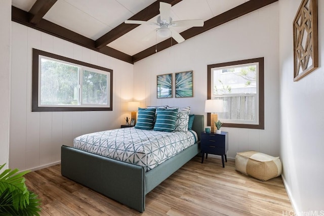 bedroom with hardwood / wood-style flooring, lofted ceiling with beams, and ceiling fan