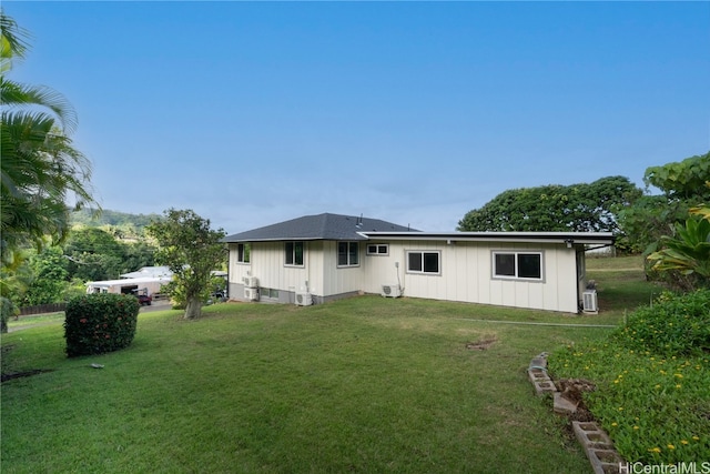 rear view of property with a yard