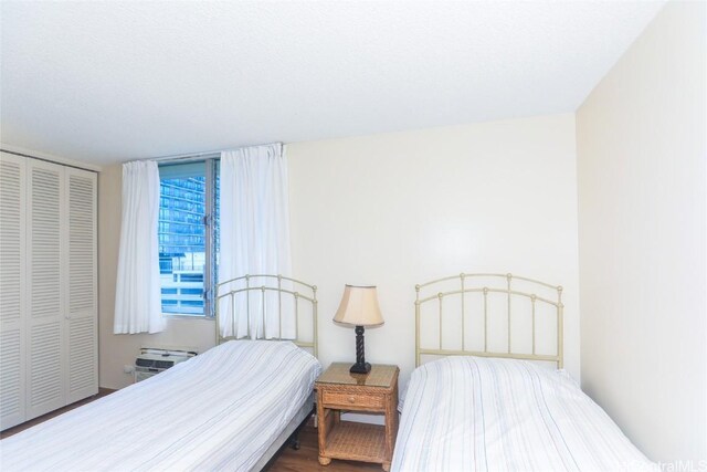 bedroom featuring hardwood / wood-style flooring and a closet