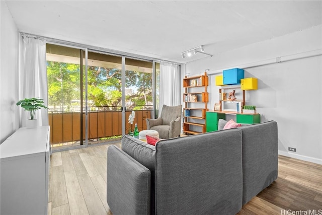 living room with hardwood / wood-style floors and track lighting