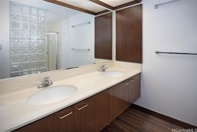 bathroom featuring hardwood / wood-style flooring, vanity, and a shower with door