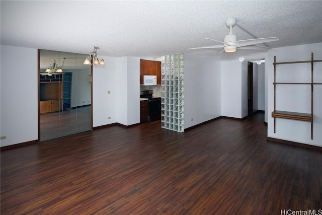 unfurnished living room featuring ceiling fan with notable chandelier, dark wood-type flooring, and a textured ceiling