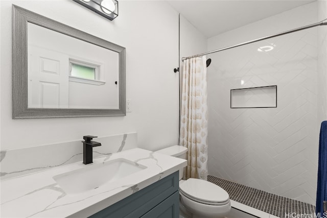 bathroom with vanity, toilet, and walk in shower