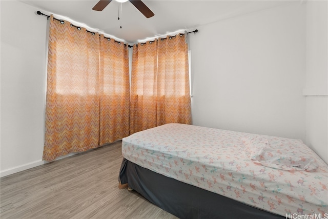 bedroom with ceiling fan and wood-type flooring