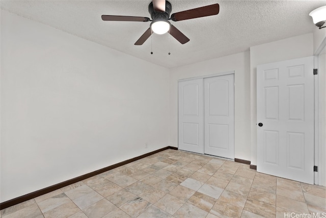 unfurnished bedroom with a textured ceiling, a closet, and ceiling fan