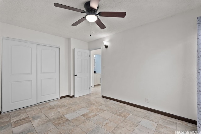 unfurnished bedroom featuring a textured ceiling, a closet, and ceiling fan