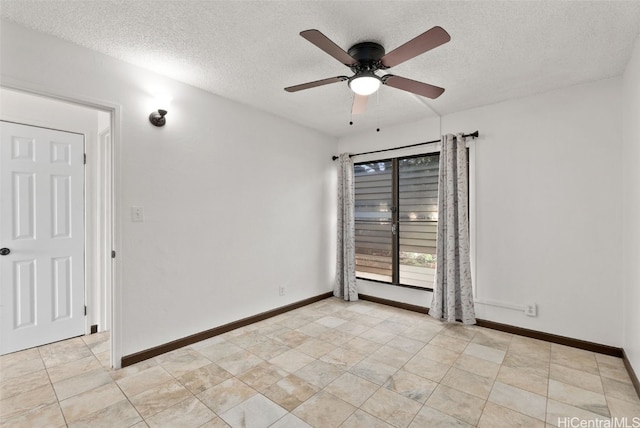 empty room featuring ceiling fan and a textured ceiling