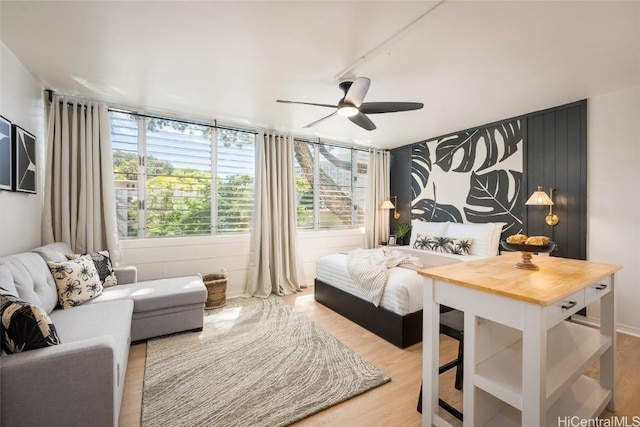 bedroom featuring ceiling fan and light hardwood / wood-style floors