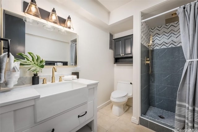 bathroom featuring toilet, vanity, a shower with curtain, and tile patterned flooring