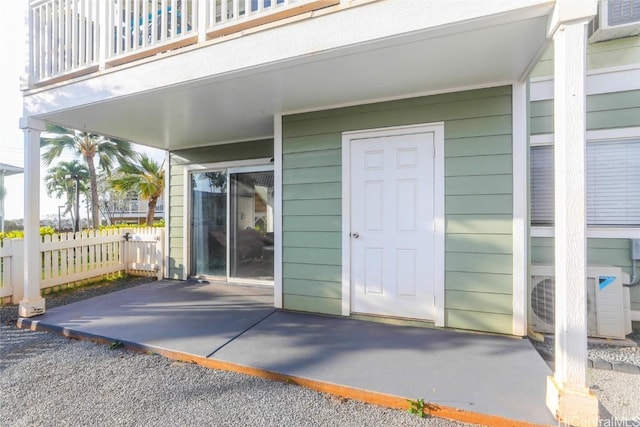 doorway to property featuring a balcony and ac unit