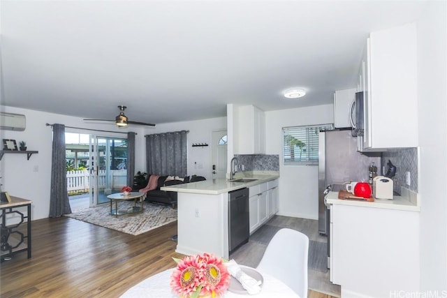 kitchen with white cabinetry, sink, dishwasher, tasteful backsplash, and kitchen peninsula