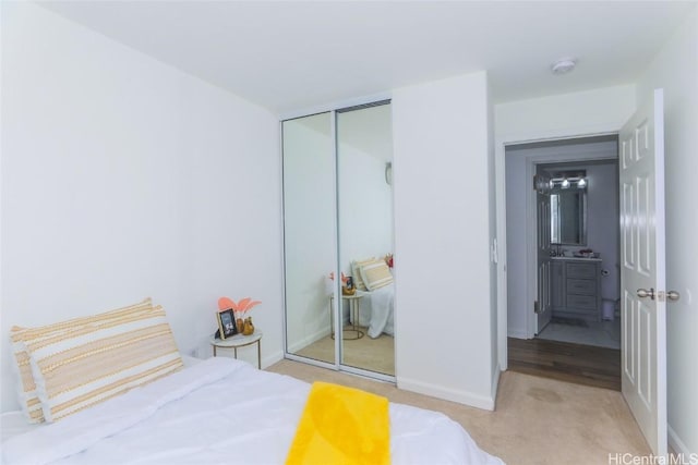 bedroom featuring light colored carpet and a closet