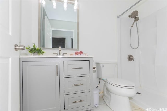 bathroom featuring tile patterned flooring, a shower, vanity, and toilet