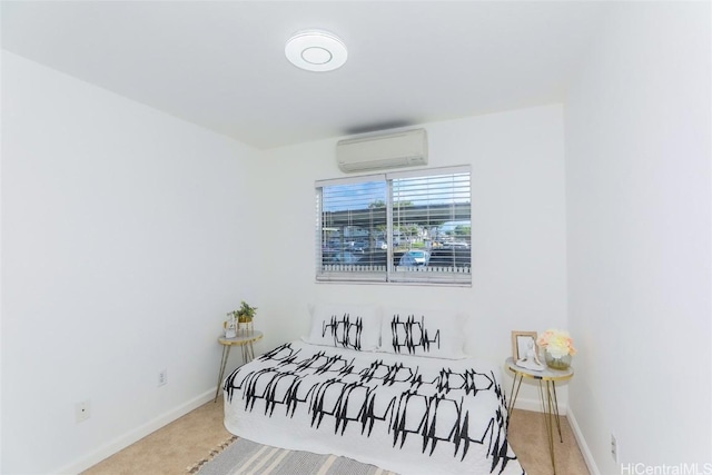 bedroom with a wall mounted AC and light colored carpet