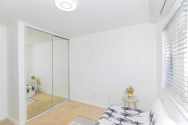 bedroom featuring light carpet and a closet