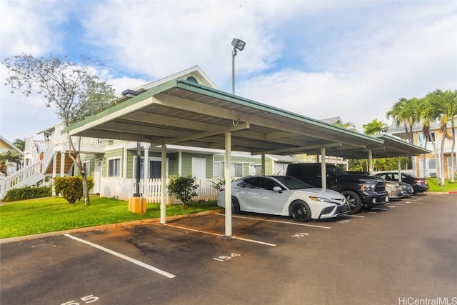 view of car parking with a carport and a lawn