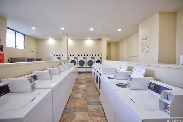 2240 Kuhio Ave Unit 3803, Penthouse Honolulu, HI 96815 - communal laundry room with independent washer and dryer, light stone finish floors, and recessed lighting