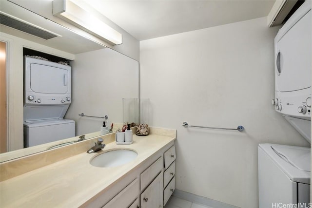 bathroom featuring vanity and stacked washer and clothes dryer