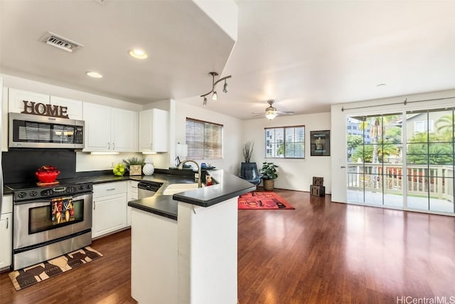 kitchen featuring ceiling fan, dark wood-type flooring, stainless steel appliances, kitchen peninsula, and white cabinets