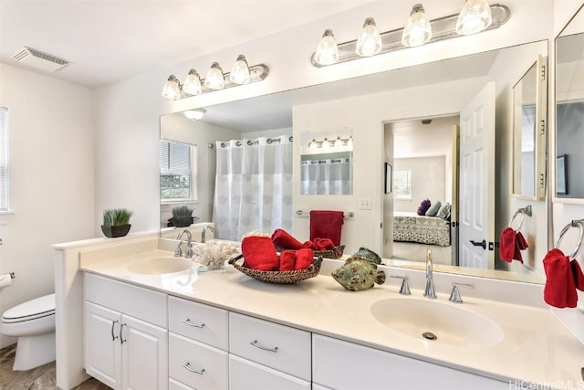 bathroom featuring vanity and toilet