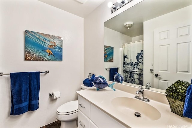 bathroom featuring tile patterned flooring, vanity, toilet, and curtained shower