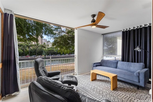 interior space with ceiling fan and a water view