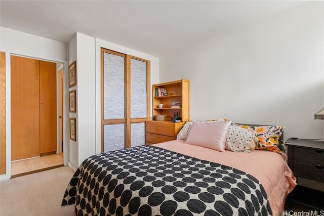 bedroom with light wood-type flooring and a closet