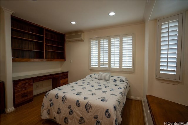 bedroom featuring a wall mounted air conditioner, crown molding, and dark wood-type flooring