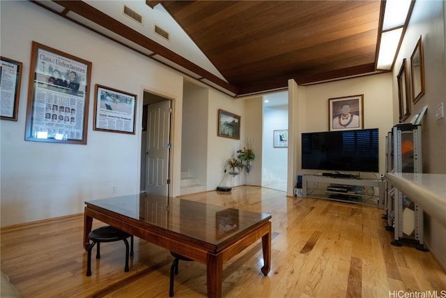 living room with lofted ceiling, light wood-type flooring, and wooden ceiling