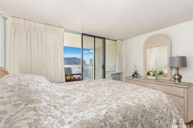 bedroom with access to exterior and a textured ceiling