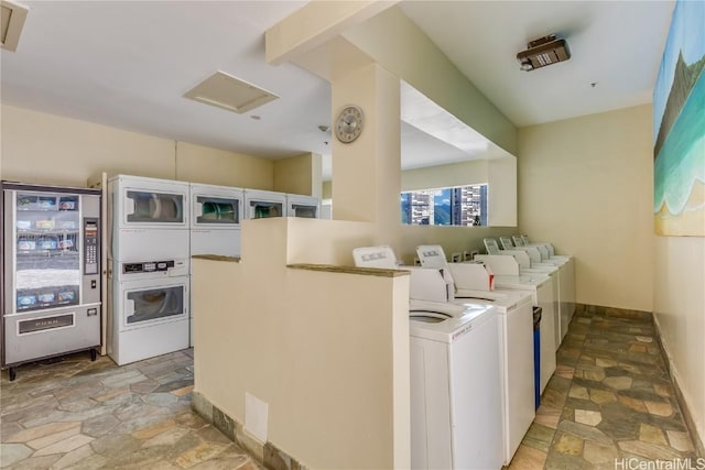 laundry room featuring washing machine and dryer and stacked washer and clothes dryer