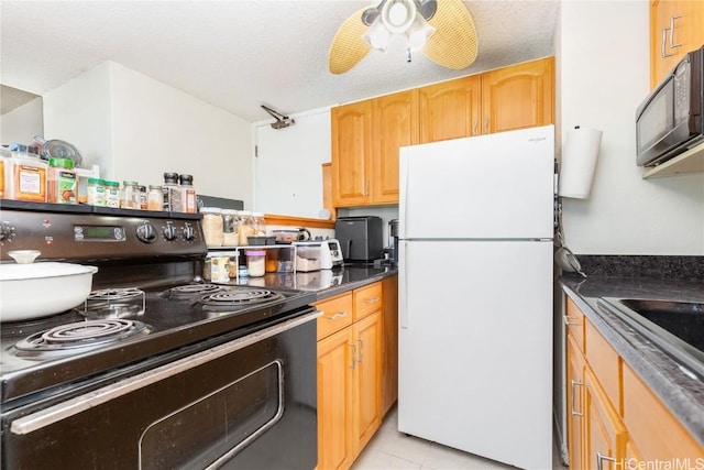 kitchen with ceiling fan, light tile patterned flooring, black appliances, and a textured ceiling