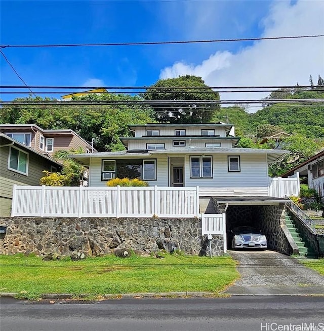 view of front of home with a front lawn and a carport