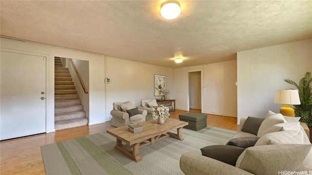 living room featuring a textured ceiling and light hardwood / wood-style flooring