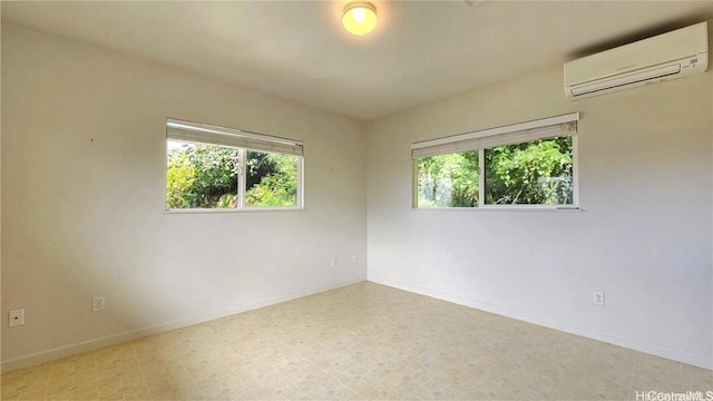 spare room with a healthy amount of sunlight and a wall mounted air conditioner