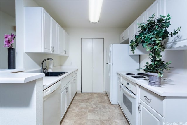 kitchen with white cabinets, range, white dishwasher, and sink