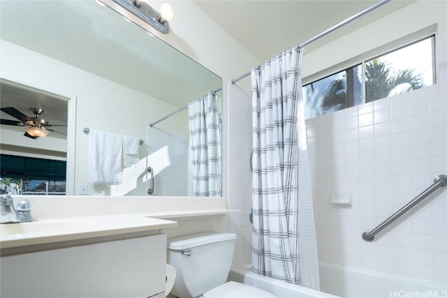 full bathroom with shower / bath combination with curtain, vanity, toilet, and ceiling fan